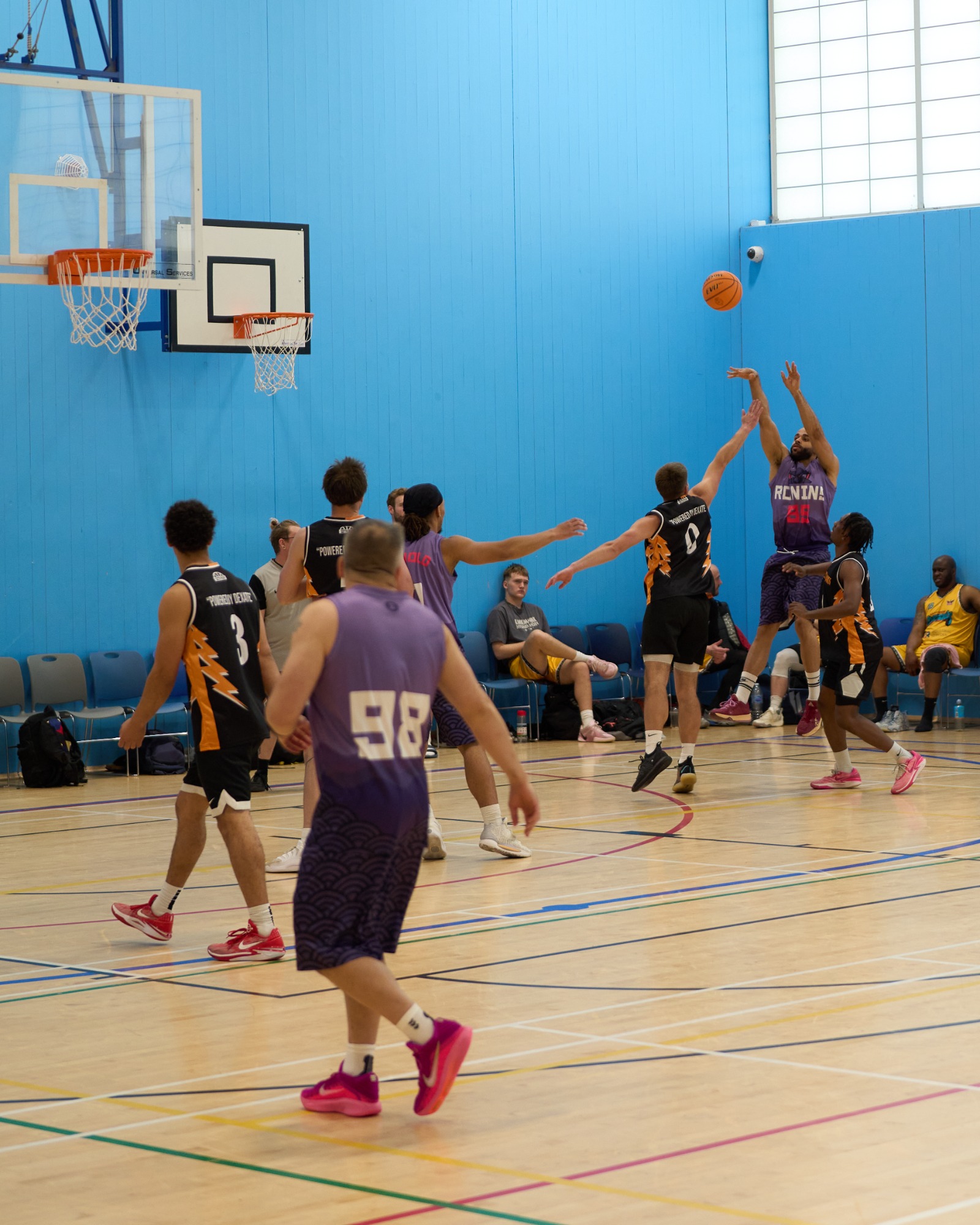 Heavily contested baseline shot, whilst jumping in mid air.