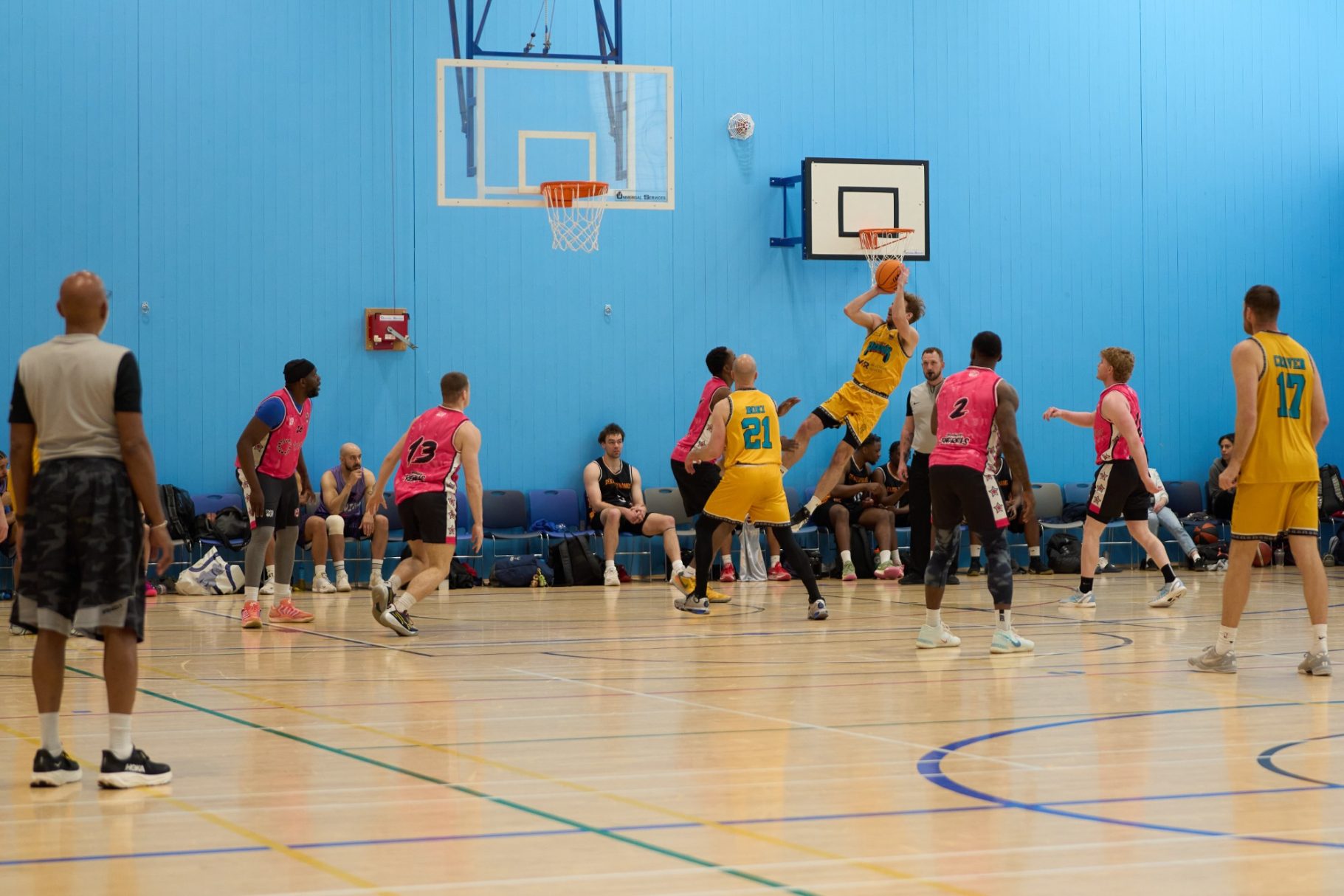 Basketball player taking a fade away jump shot.