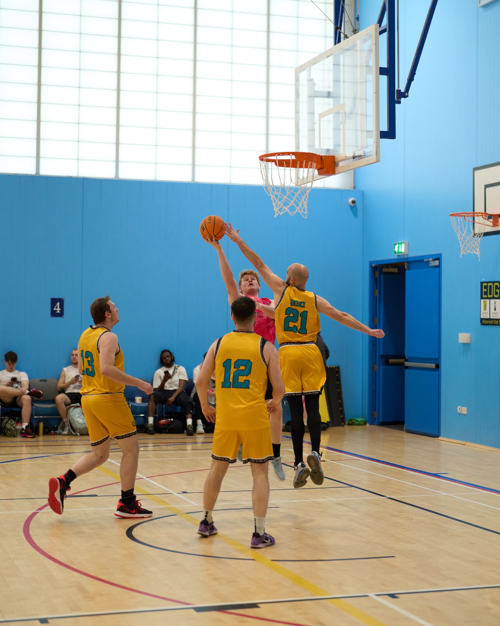 Blocked shot on a shooter trying to make a shot with the basketball.