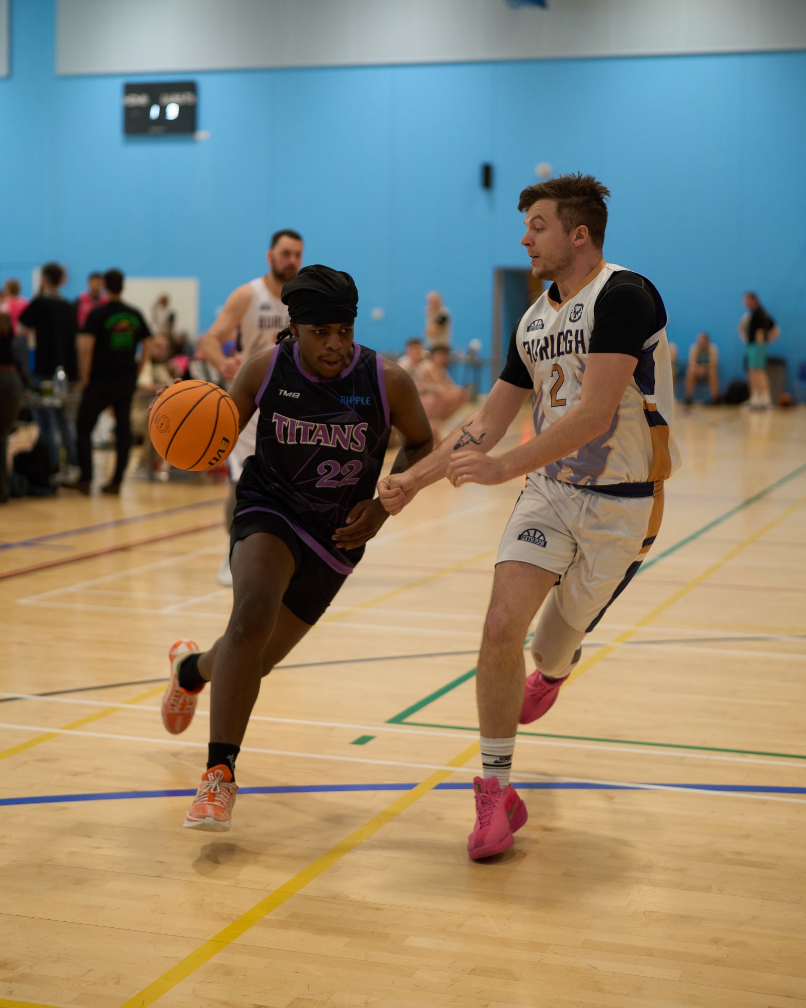 Close up of a player dribbling whilst being closely defended.